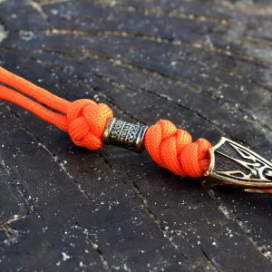 Фото оранжевый темляк из паракода для ножа с бусиной и трезубцем